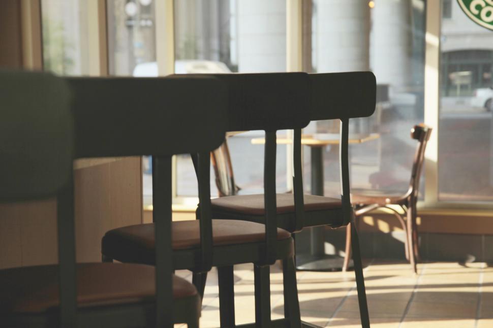 Free Image of Row of Chairs in Front of Window 