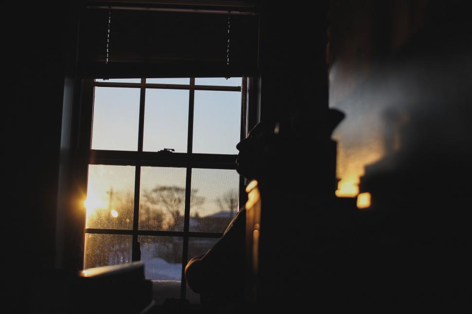 Free Image of Sun Shining Through Window in Dark Room 