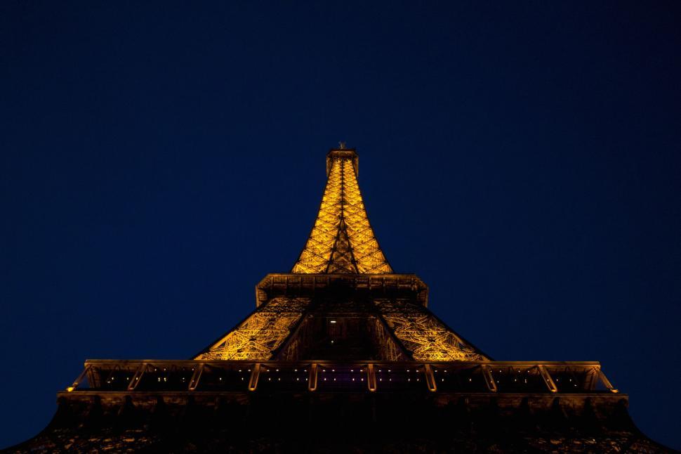 Free Image of The Illuminated Top of the Eiffel Tower at Night 