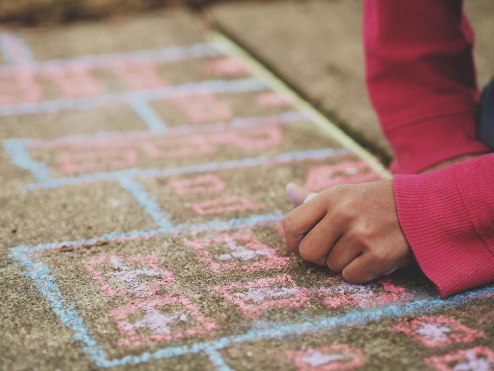 Free Image of Child Drawing With Chalk on Sidewalk 