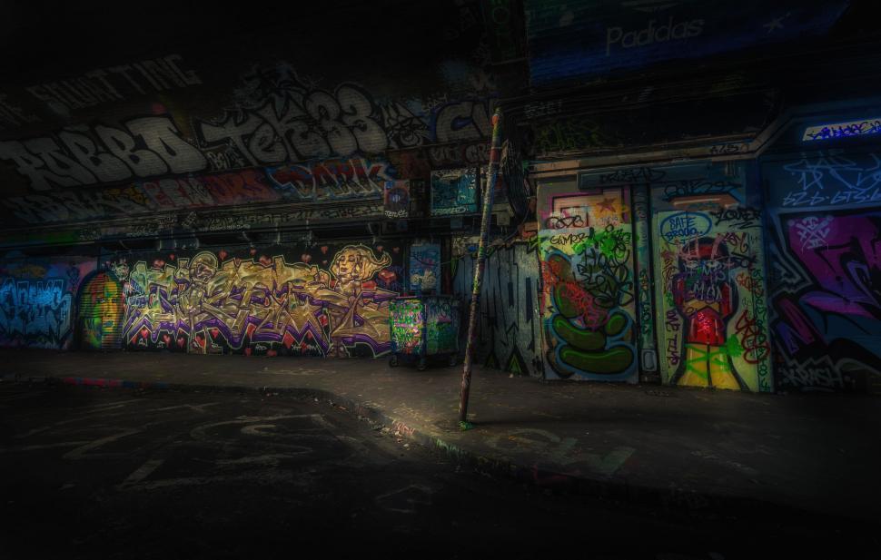 Free Image of Wall Covered in Graffiti in Dark Room 