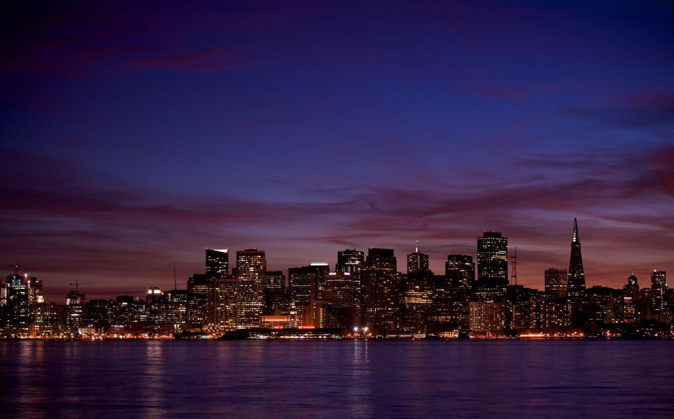 Free Image of City Skyline Illuminated at Night Across the Water 