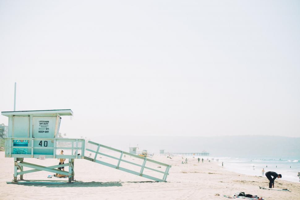 Free Image of Lifeguard Stand on Beach With Tower in Background 