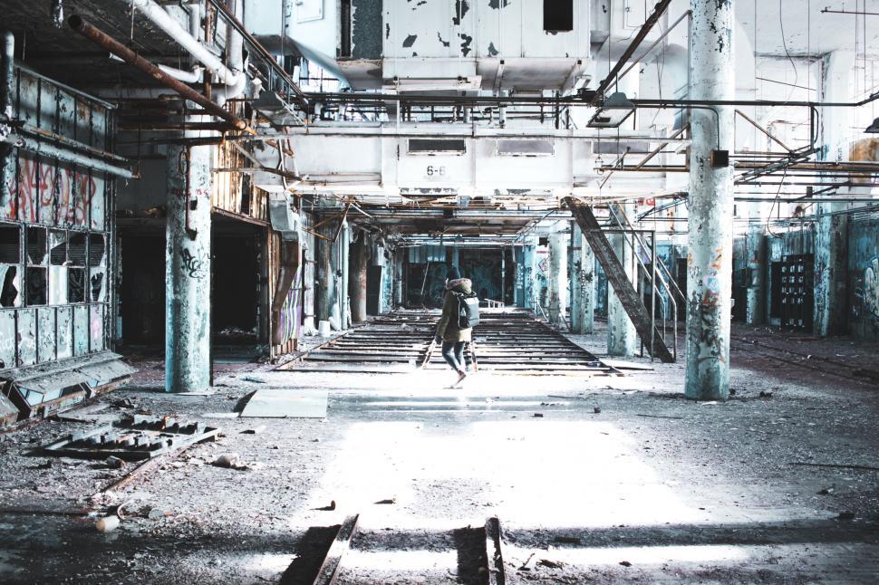 Free Image of Man Walking Through Abandoned Building 