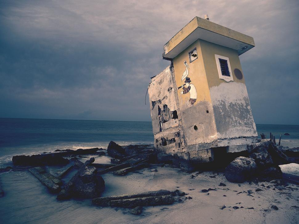 Free Image of Small Building on Sandy Beach 