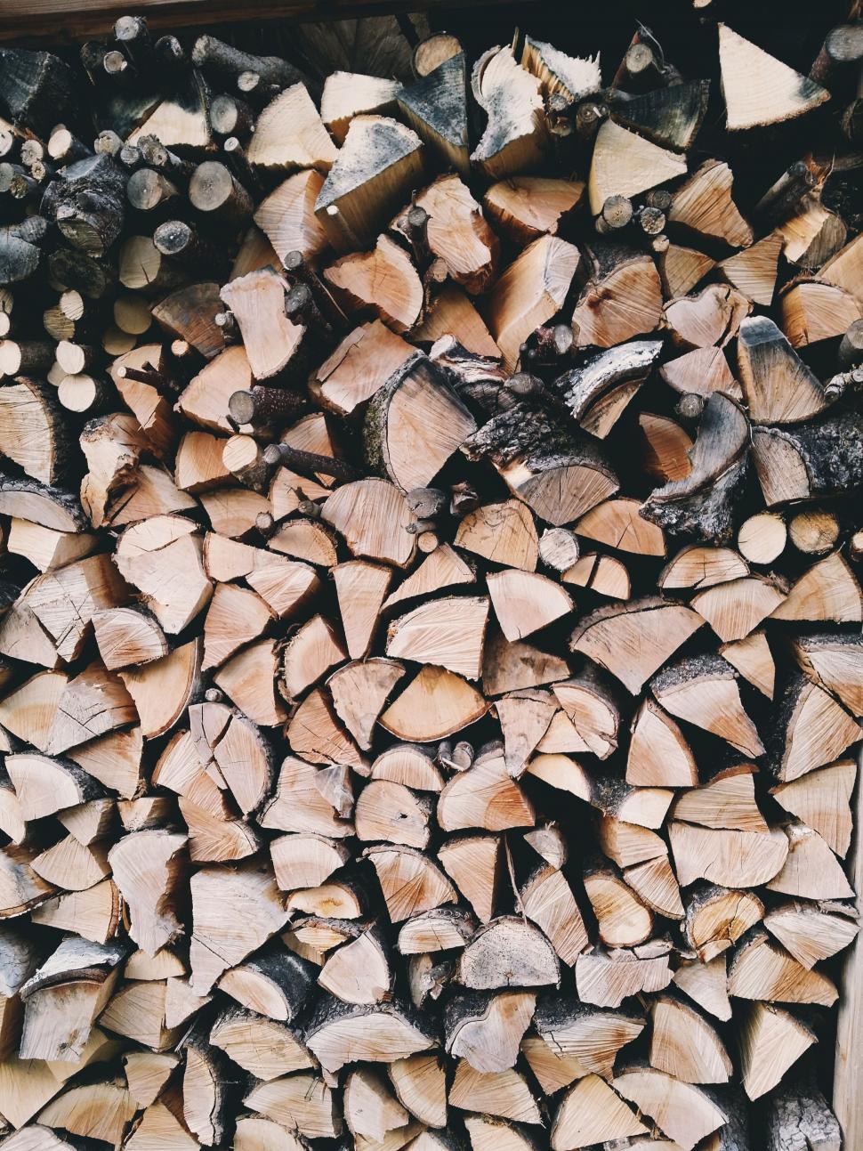 Free Image of Pile of Wood Next to Logs 