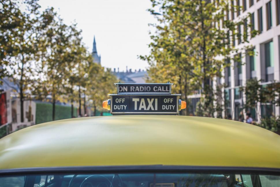 Free Image of Taxi Cab With Street Sign 