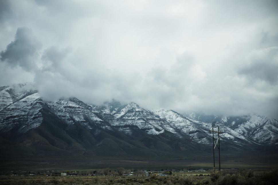 Free Image of Cloudy Sky Over Mountain Range With Telephone Pole 