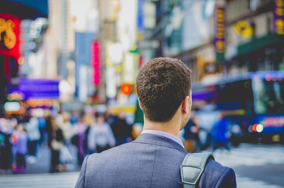 Free Image of Man With Backpack Observing Busy City Street 