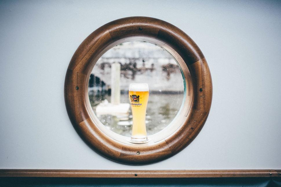 Free Image of Round Mirror Reflecting Glass of Beer 