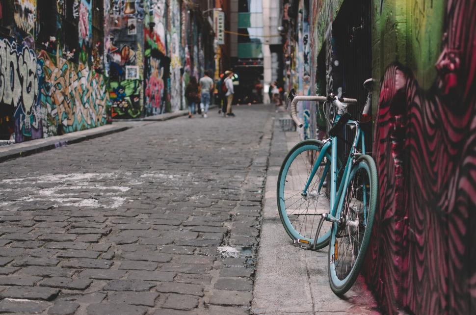 Free Image of Bike Parked Next to Graffiti-Covered Wall 