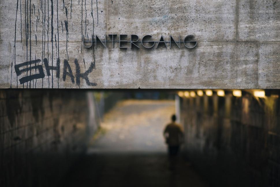 Free Image of Man Walking Down Tunnel Under Bridge 