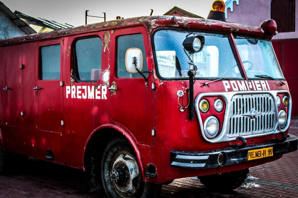Free Image of Old Red Fire Truck Parked on Side of Road 