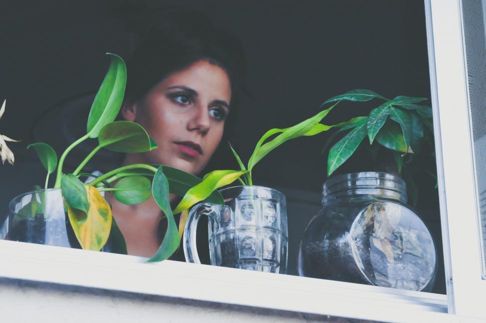 Free Image of Woman Looking Out of Window 