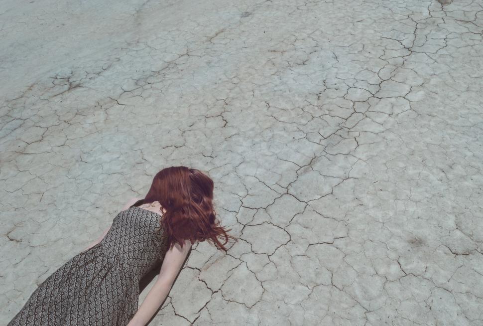 Free Image of Woman Standing in Cracked Road 