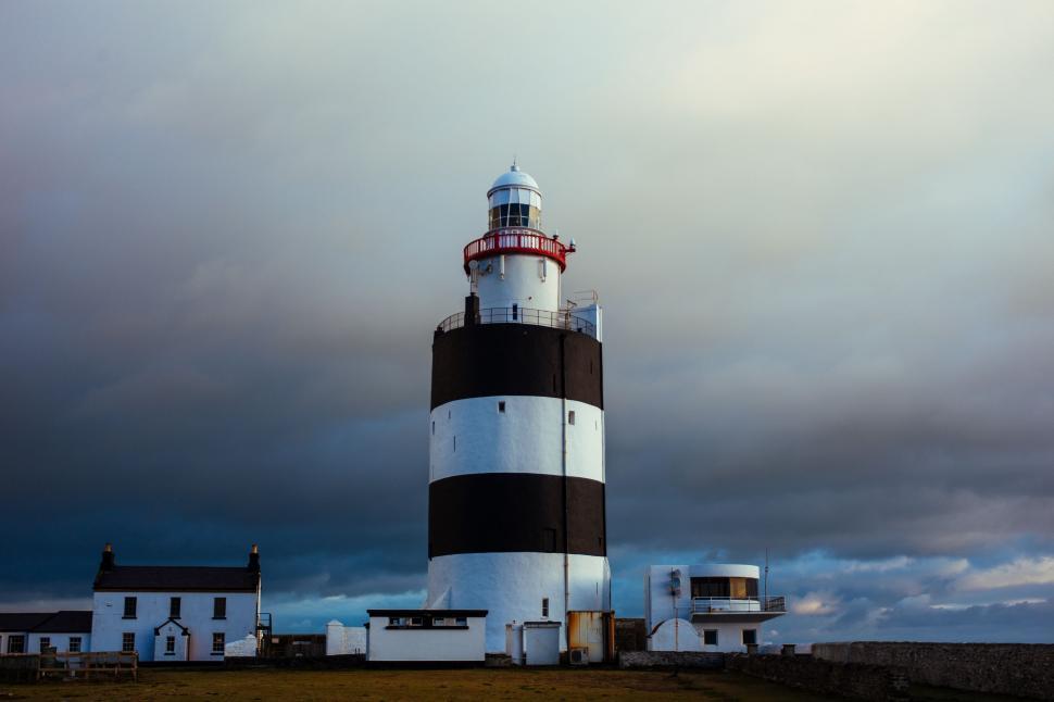 Free Image of Black and White Lighthouse Under Cloudy Sky 