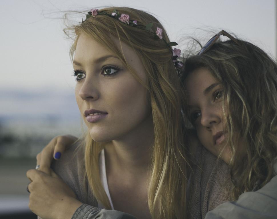 Free Image of Two Beautiful Young Women Standing Together 