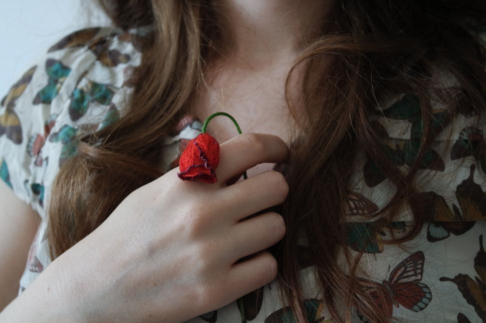 Free Image of Woman Holding Red Flower 