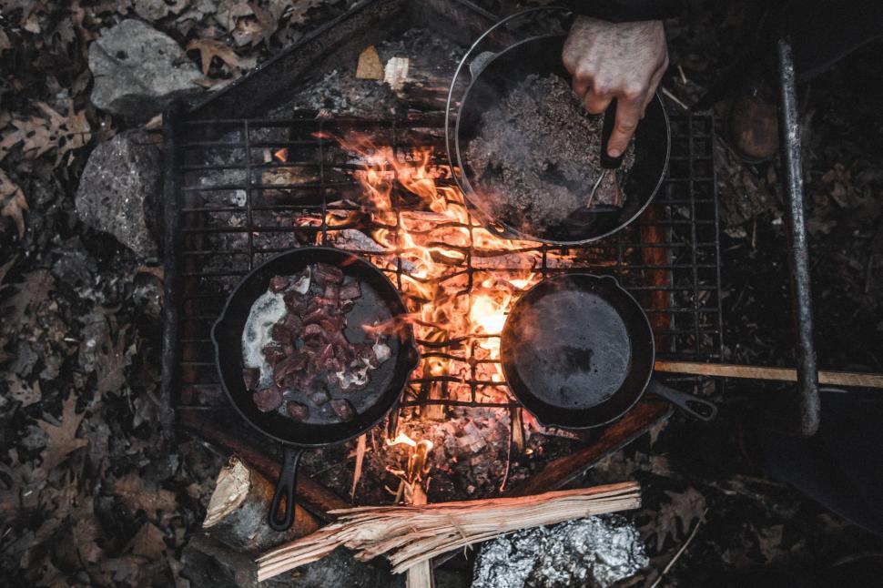 Free Image of Person Cooking on Grill in the Woods 