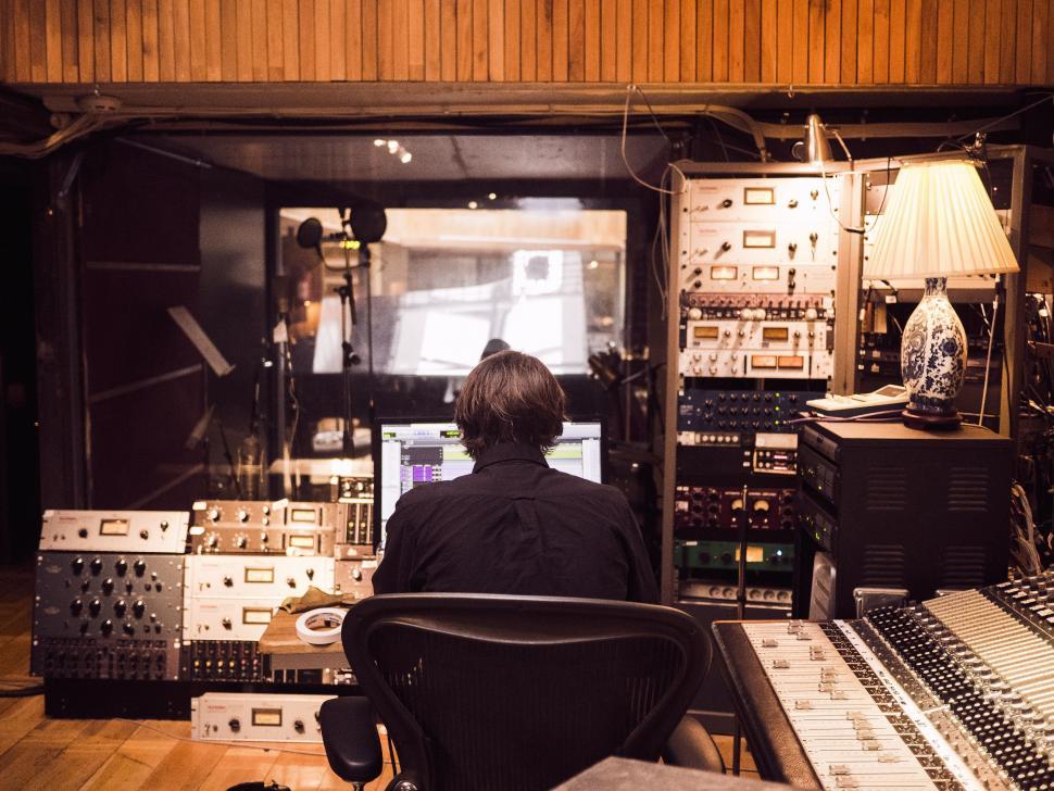 Free Image of Man Sitting at Desk in Recording Studio 