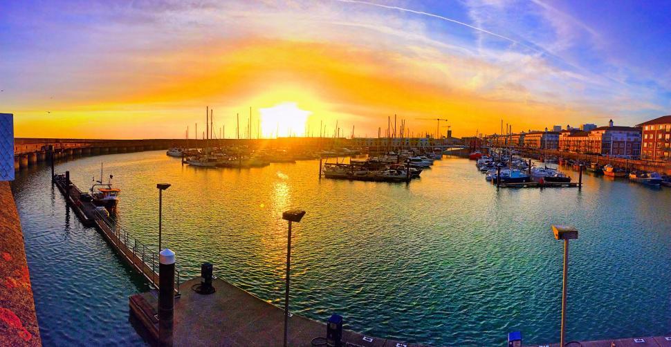 Free Image of Sun Setting Over Harbor Full of Boats 