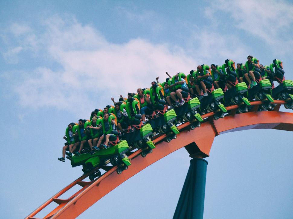 Free Image of Group of People Riding on Top of a Roller Coaster 