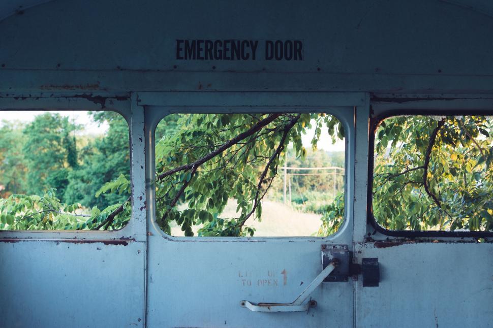 Free Image of The Door of an Old Train With Trees in the Background 