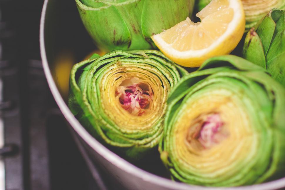 Free Image of Pot Filled With Artichokes and Lemon Wedges 