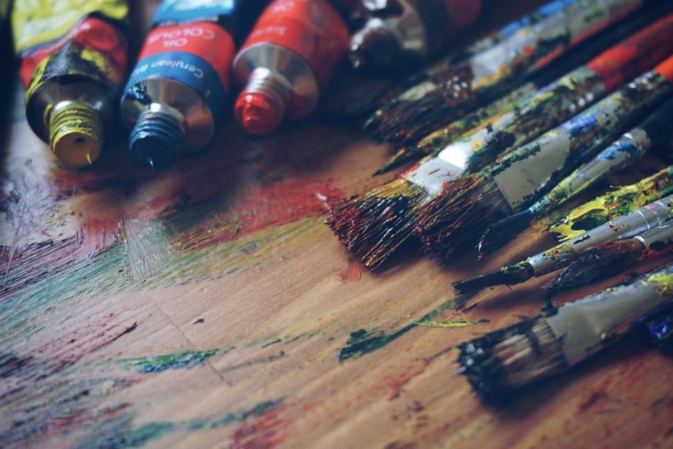 Free Image of Assorted Paint Brushes on Wooden Table 