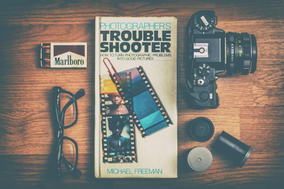 Free Image of Book, Camera, and Various Objects on Table 