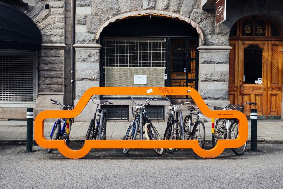 Free Image of Orange Car-Shaped Bike Rack in Front of Building 