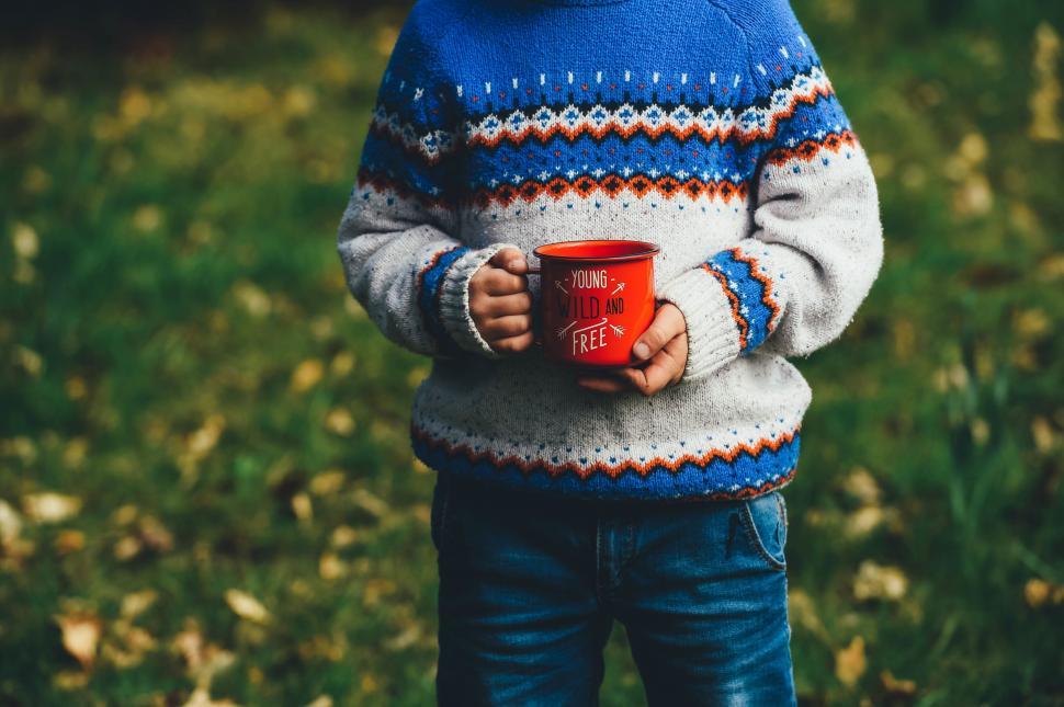 Free Image of Little Boy Holding Red Cup 
