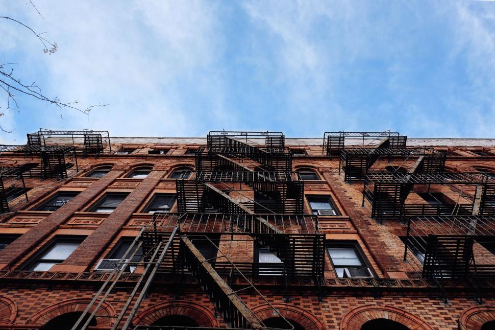 Free Image of Tall Brick Building With Lots of Windows 