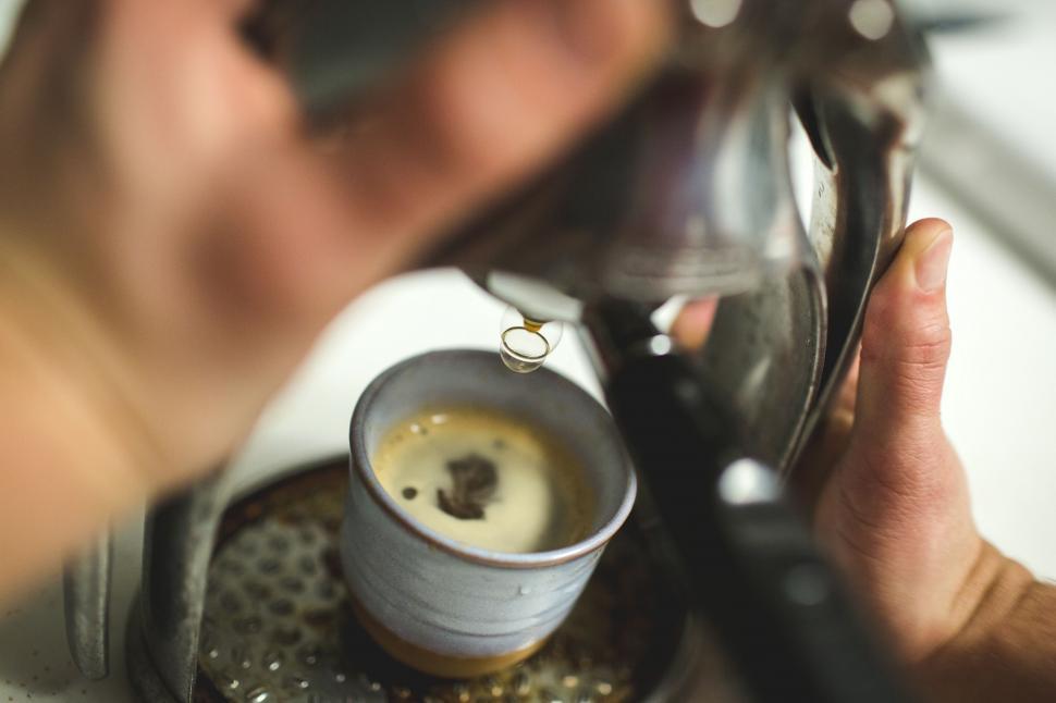 Free Image of Person Pouring Cup of Coffee From Coffee Maker 