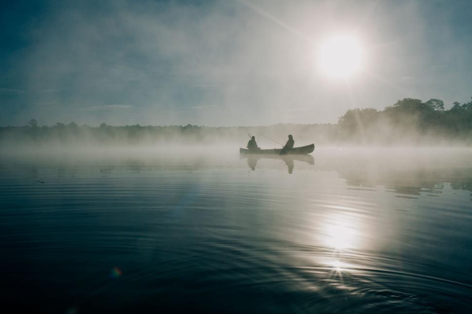 Free Image of Two People Rowing Boat on Foggy Lake 