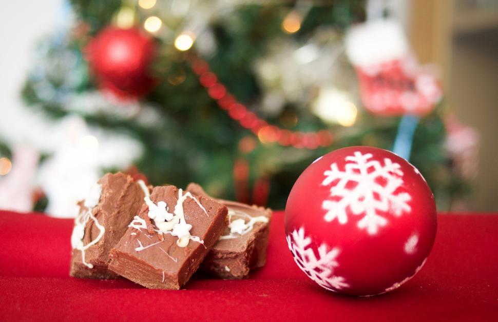 Free Image of Christmas Ornament Next to Pile of Chocolate 