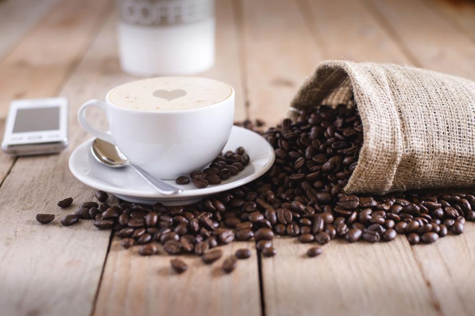 Free Image of Cup of Coffee Next to Bag of Coffee Beans 
