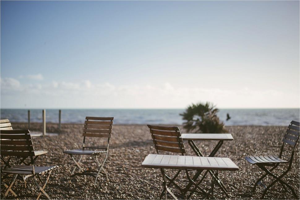 Free Image of Row of Chairs on Sandy Beach 