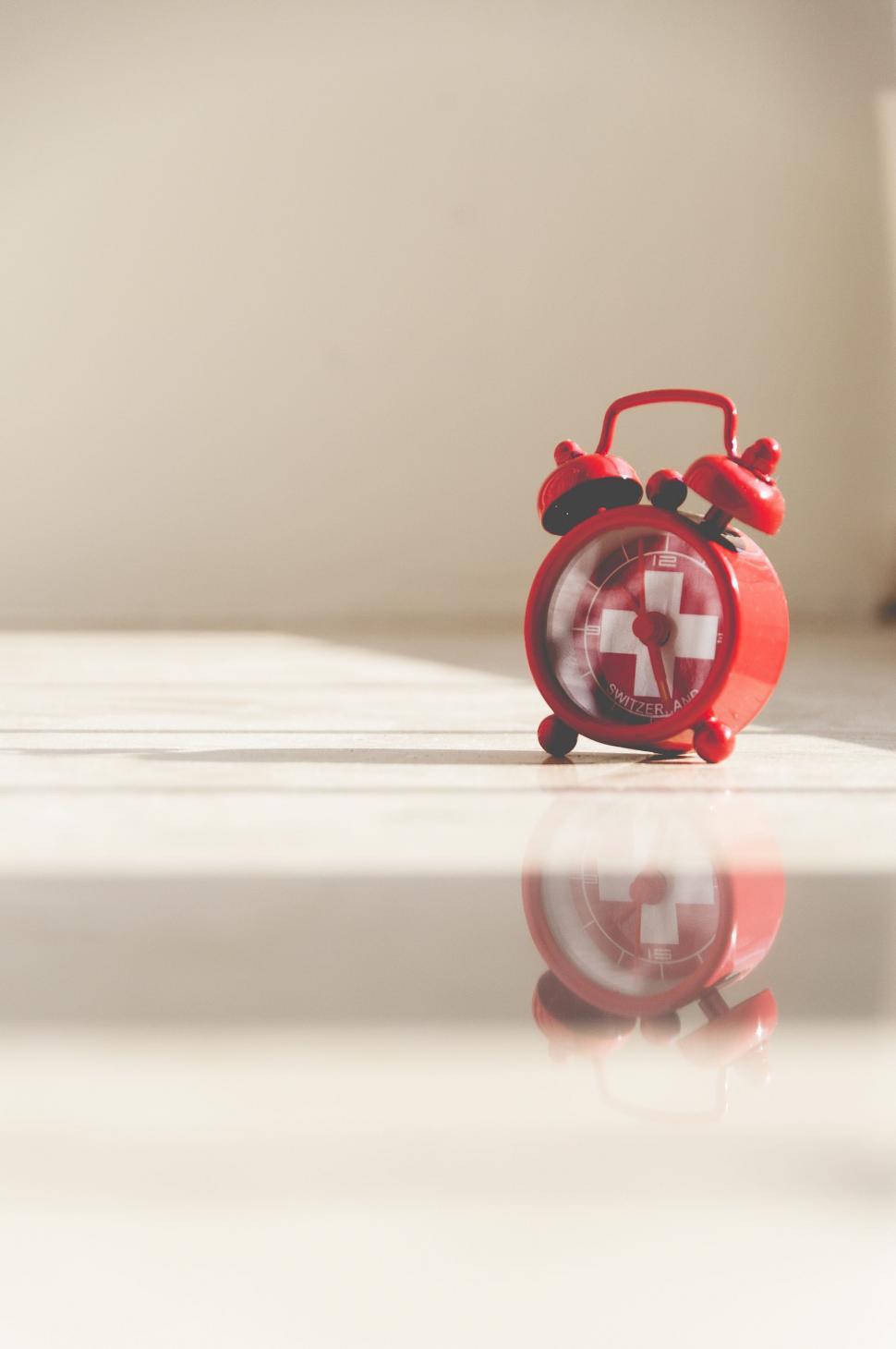 Free Image of Red Alarm Clock on White Counter 