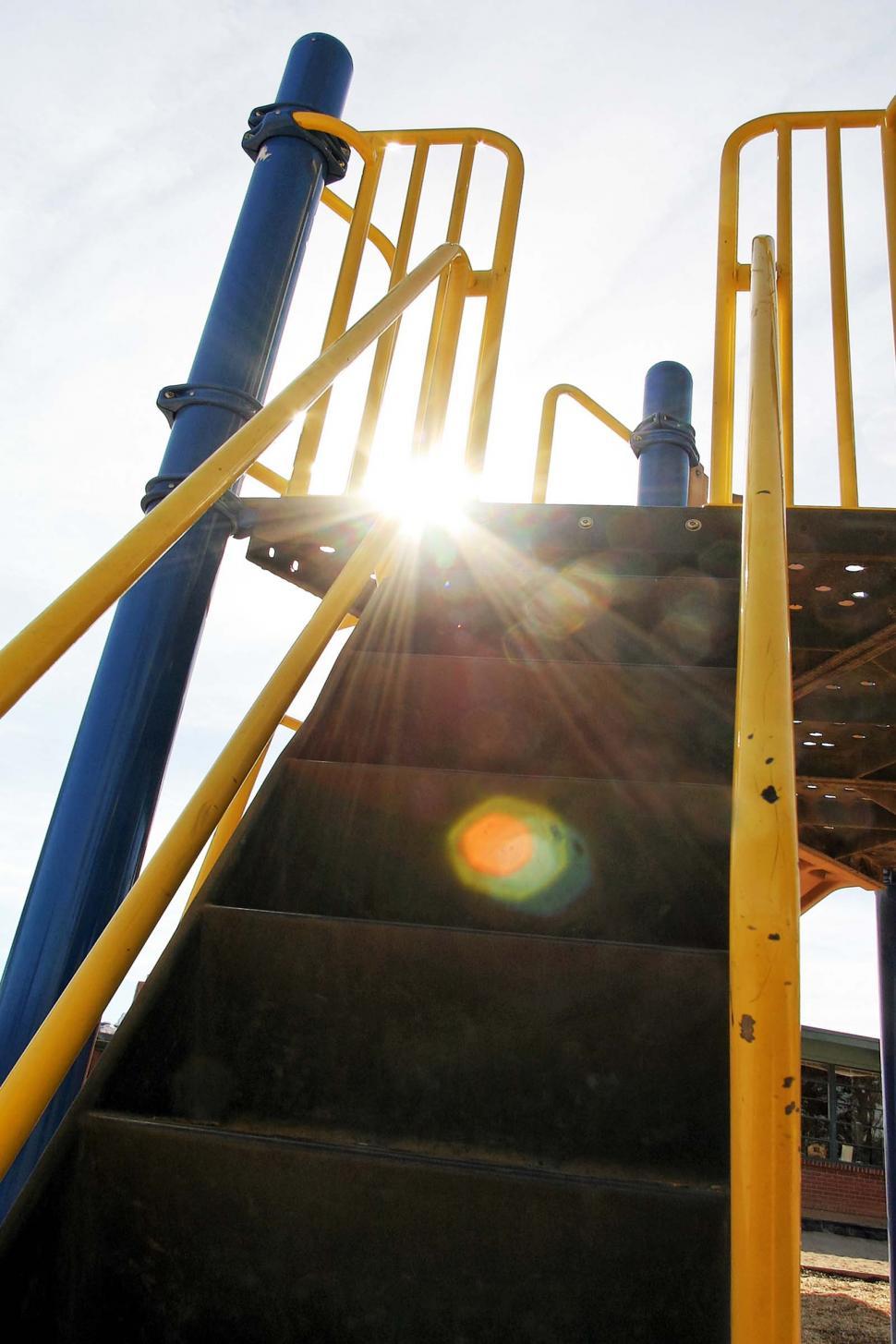 Free Image of playground school climb steps stairs handrail high tall sun flair glare blinding ascent 