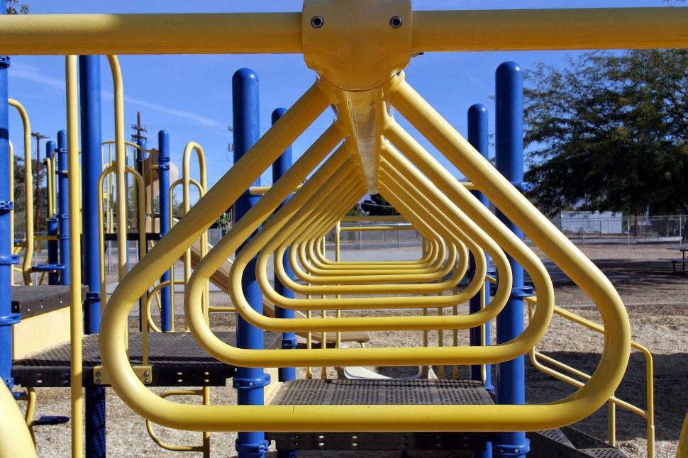 Free Image of Row of Yellow Pipes on Playground 