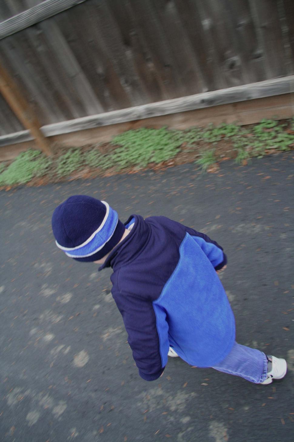 Free Image of Small Child in Blue Jacket and White Shoes 