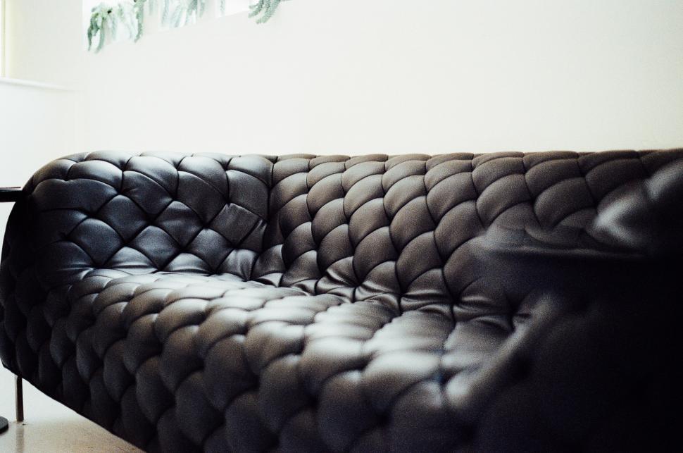 Free Image of Black and White Photo of a Couch in a Living Room 