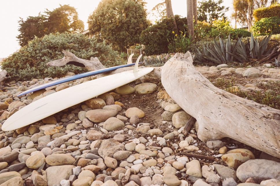 Free Image of White Surfboard on Pile of Rocks 
