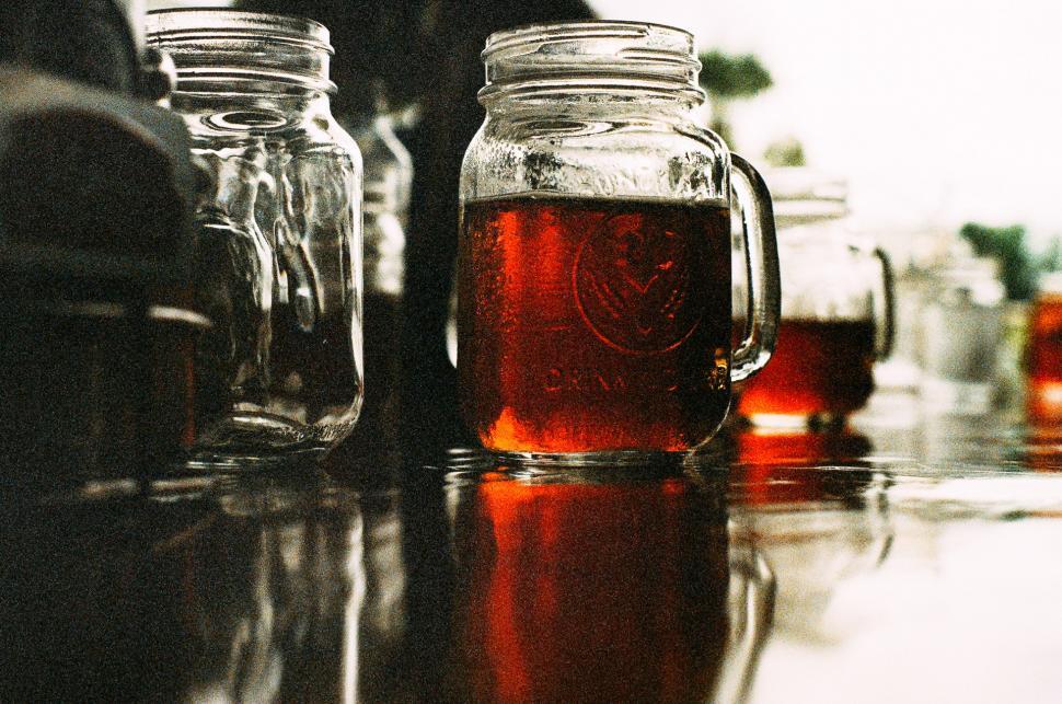 Free Image of Table With Jars Filled With Liquid 