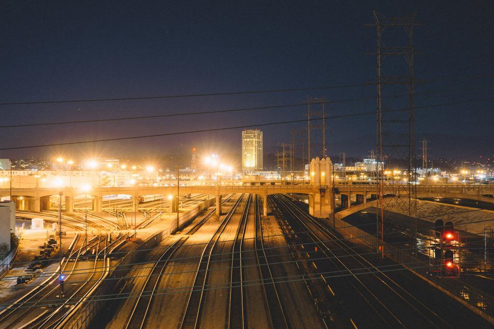 Free Image of Train Yard at Night With Train on Tracks 