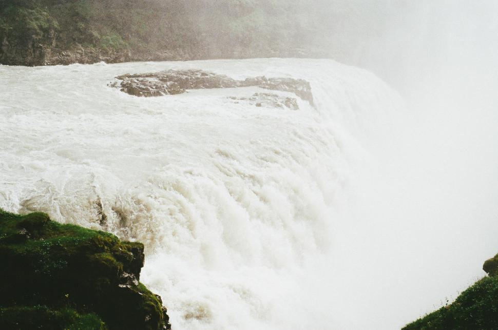 Free Image of Man Standing on Edge of Waterfall 