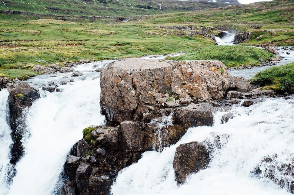 Free Image of Small Waterfall in Grassy Field 