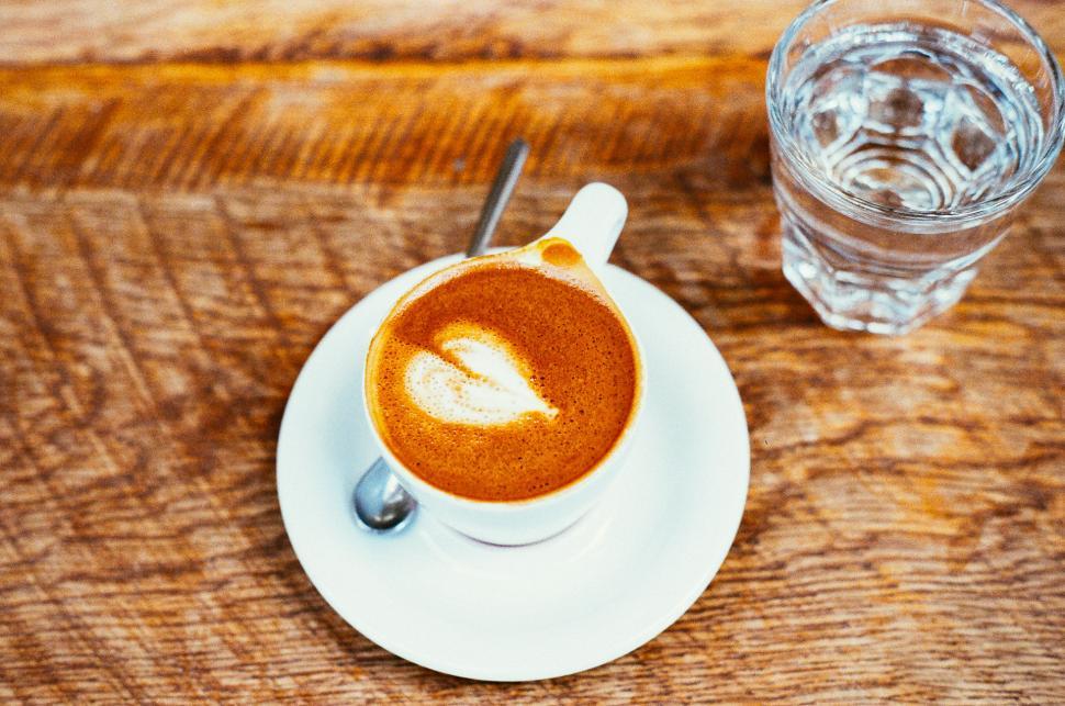 Free Image of A Cup of Cappuccino and Spoon on a Saucer 