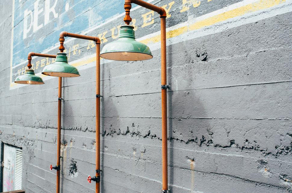Free Image of Row of Green Lamps on Brick Wall 